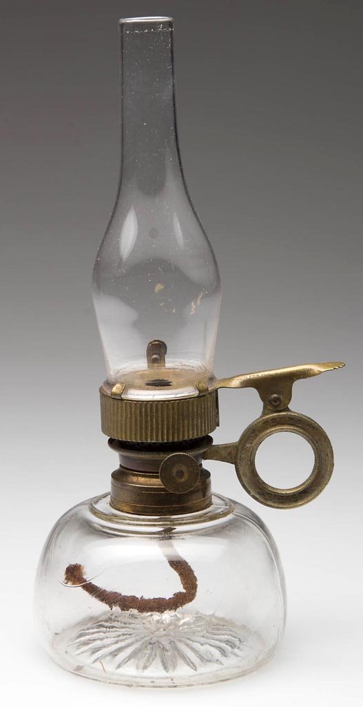 TOM THUMB DIRIGO FINGER LAMP: TOM THUMB DIRIGO FINGER LAMP, colorless glass, embossed star pattern on underside, with RARE Cahoon burner with thumbwheel marked "Tom Thumb Dirigo" on wick riser and finger ring with thumb screw. Pat