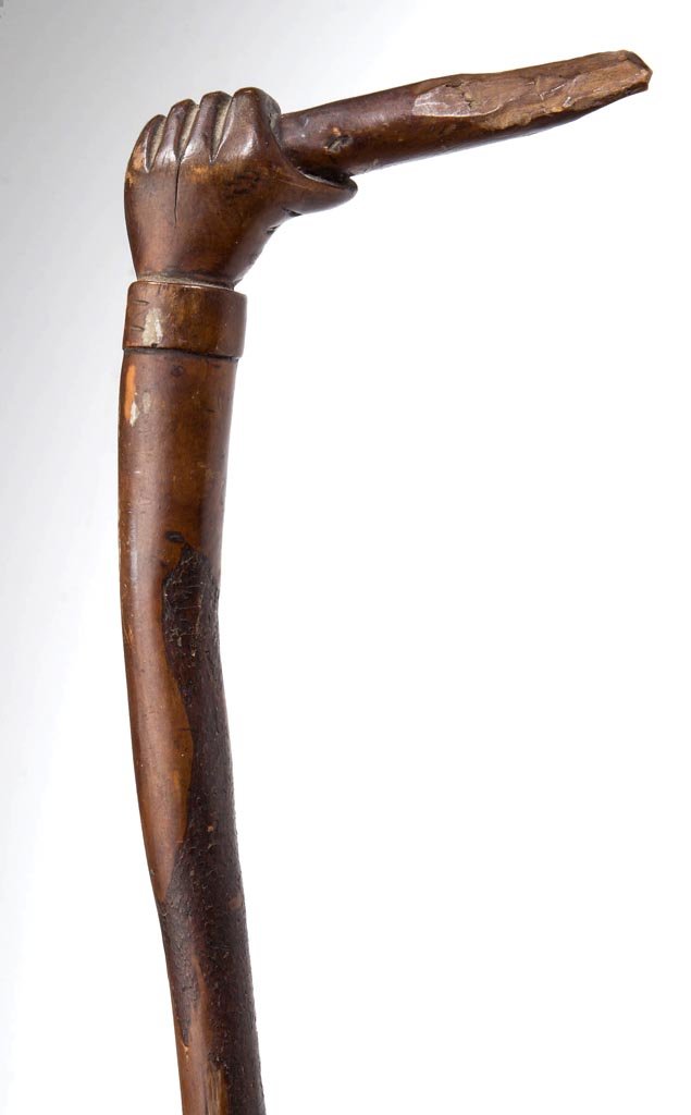 SOUTHERN, POSSIBLY WEST VIRGINIA, CARVED FOLK ART CANE: SOUTHERN, POSSIBLY WEST VIRGINIA, CARVED FOLK ART CANE / WALKING STICK, a fine example with plain shaft still retaining bark, topped with a delicately carved hand grasping a stick. Beautiful original