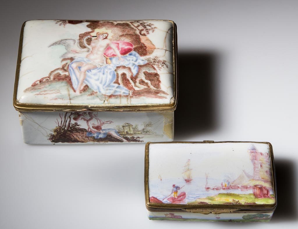 BATTERSEA / BILTSON ENAMEL SNUFF BOXES, LOT OF TWO: BATTERSEA / BILTSON ENAMEL SNUFF BOXES, LOT OF TWO, each with hinged lid and gilt-metal mounts, large example hand-painted with partially clothed female figures on exterior and a lady playing a keyboa