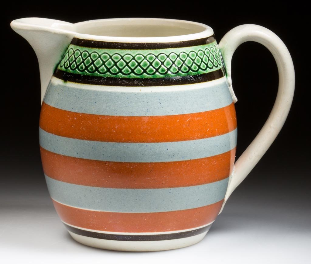 ENGLISH STAFFORDSHIRE PEARLWARE MOCHA-DECORATED: ENGLISH STAFFORDSHIRE PEARLWARE MOCHA-DECORATED ENGINE-TURNED AND ROULETTED POTTERY PITCHER, bulge-waist form with everted spout and simple applied handle, a band of engine-turned serpentine patterns