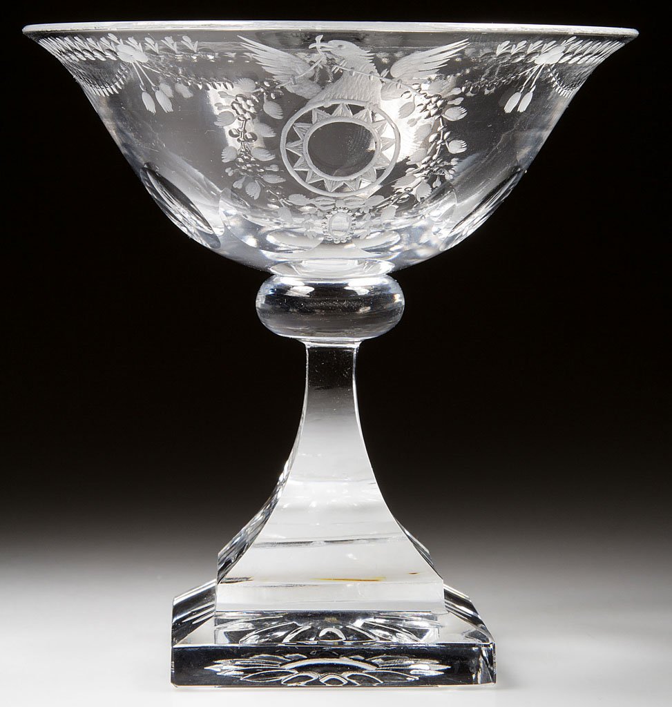 STEUBEN "STRAWBERRY MANSION" PATTERN CUT CHAMPAGNE: STEUBEN "STRAWBERRY MANSION" PATTERN CUT CHAMPAGNE GLASS, colorless, spread-wing eagle crest, raised on a stepped square base, not signed. Steuben Glass Works. Designed by Frederick Carder in 1931. 4 
