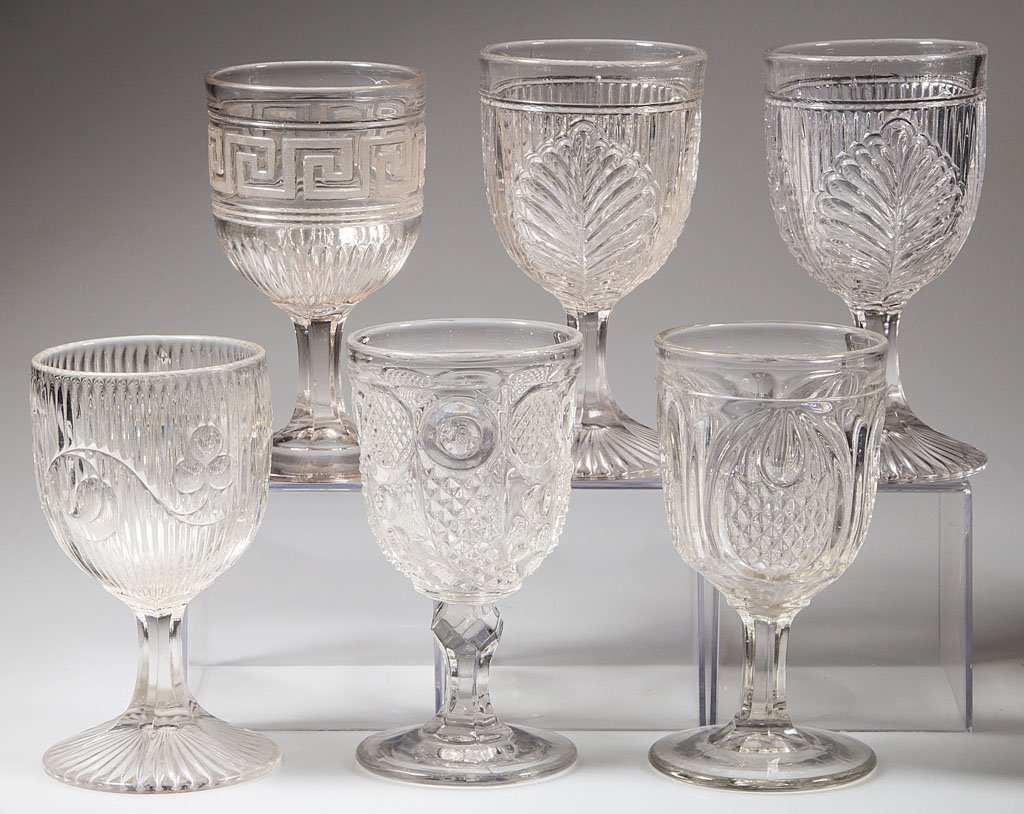 ASSORTED EAPG GOBLETS, LOT OF SIX: ASSORTED EAPG GOBLETS, LOT OF SIX, colorless lead glass, comprising two Ribbed Palm, a Bellflower, Horn of Plenty, Greek Key, and New England Pineapple. Third quarter 19th century. 5 7/8" to 6 1/4" H.
