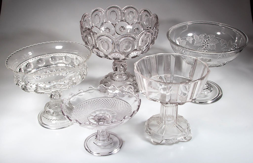 ASSORTED EAPG OPEN COMPOTES, LOT OF FIVE: ASSORTED EAPG OPEN COMPOTES, LOT OF FIVE, colorless, including King's Crown, Moon and Star, and Current. Fourth quarter 19th century. 5 1/2" to 11" H, 8" to 10 1/2" D. Provenance: From a New England p