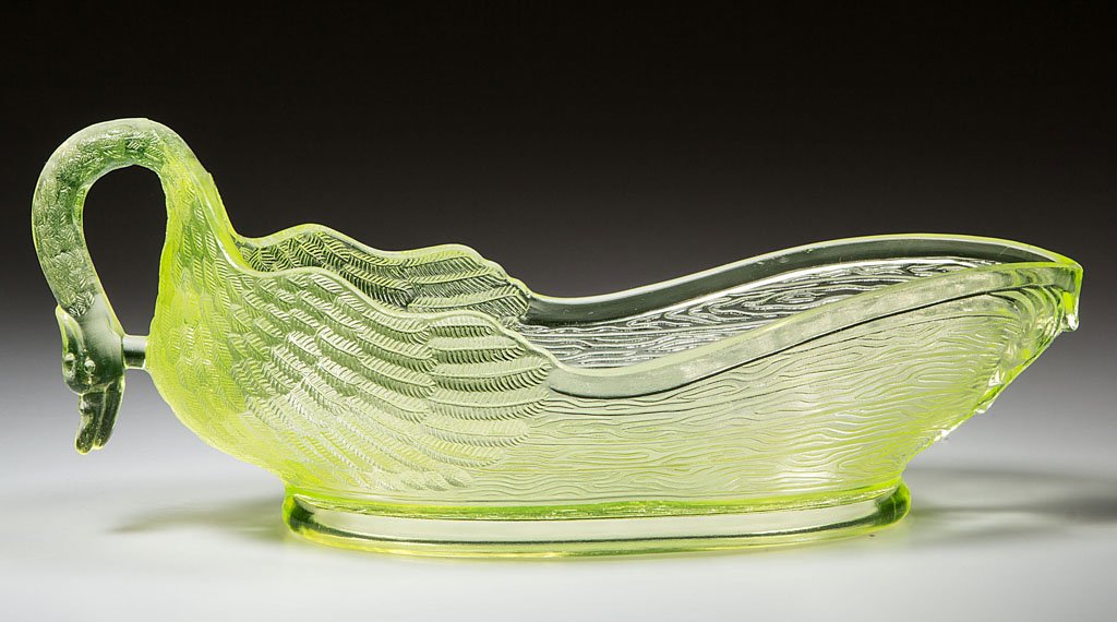 SWAN OVAL DISH: SWAN OVAL DISH, vaseline (uranium). Central Glass Co. Fourth quarter 19th century. 3 3/4" HOA, 9" L. Literature: Hallock - Central Glass Company, p. 258, no. 819. Peterson - Vaseline Glass, p. 137. Pr