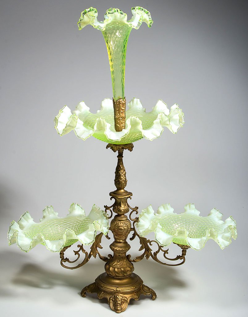 VICTORIAN GLASS EPERGNE: VICTORIAN GLASS EPERGNE, vaseline (uranium) opalescent, gold-painted white metal stand fitted with three ruffled-rim bowls and a central trumpet-form vase, each molded with a diamond-optic pattern. Fo