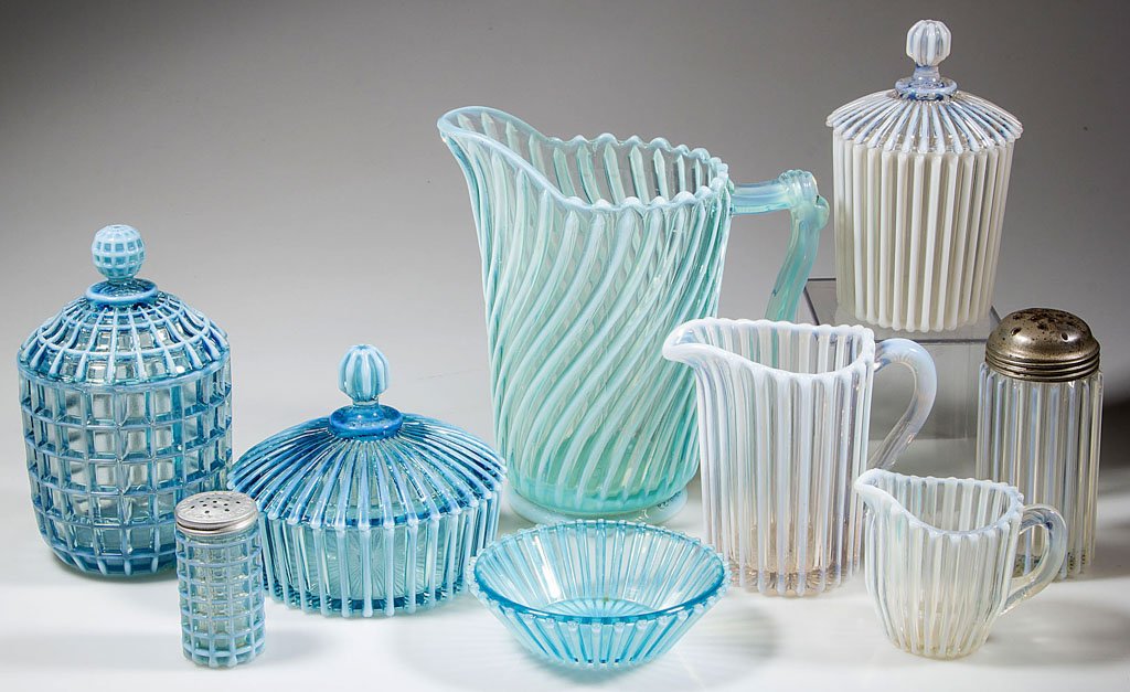 A. J. BEATTY OPALESCENT GLASS ARTICLES, LOT OF NINE: A. J. BEATTY OPALESCENT GLASS ARTICLES, LOT OF NINE, blue and colorless opalescent, comprising six Beatty Rib examples including two creamers, a sugar shaker, covered butter dish, covered sugar bowl a