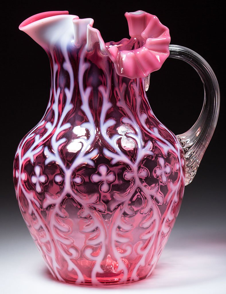 OPALINE BROCADE / SPANISH LACE WATER PITCHER: OPALINE BROCADE / SPANISH LACE WATER PITCHER, cranberry opalescent, shouldered form with three-section crimped and ruffled rim, applied colorless reeded handle. National Glass Co. Pattern introduced 1