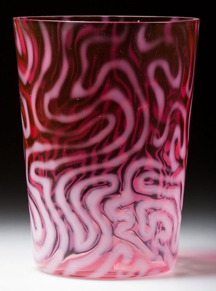 SWIRLING MAZE TUMBLER: SWIRLING MAZE TUMBLER, cranberry opalescent, factory polished rim. Attributed to the Jefferson Glass Co. Circa 1905. 3 7/8" H. Provenance: From the collection of Larry & Diana Nellans.