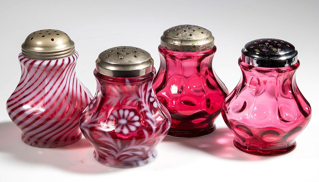 L. G. WRIGHT NINE-PANEL MOLD SUGAR SHAKERS, LOT OF FOUR: L. G. WRIGHT NINE-PANEL MOLD SUGAR SHAKERS, LOT OF FOUR, comprising two Inverted Thumbprint, a cranberry opalescent Swirl and Daisy and Fern, period lids. 20th century. 4 3/8" to 4 1/2" HOA.