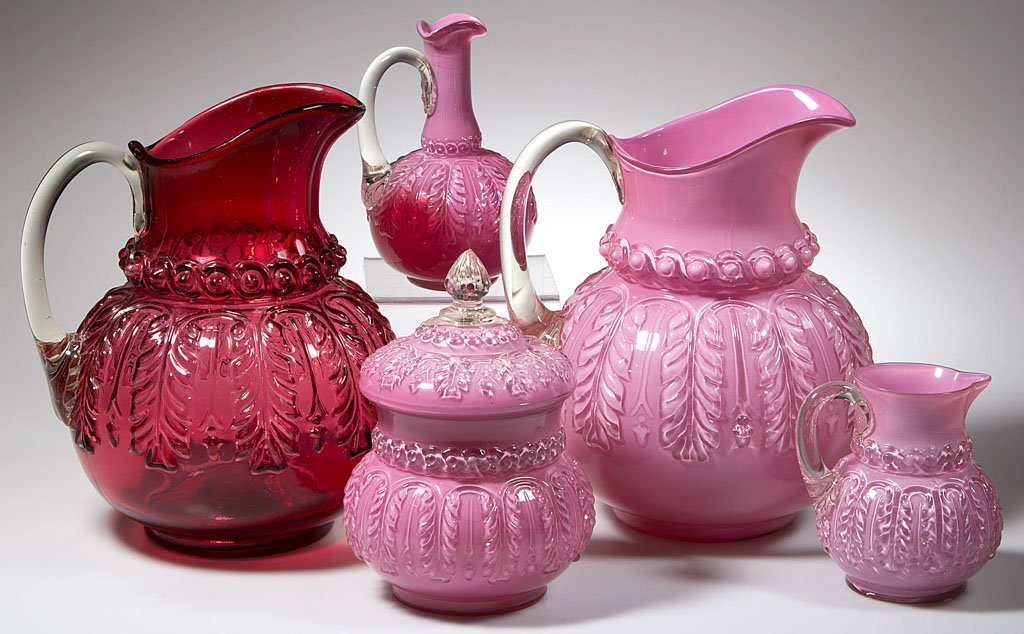 NORTHWOOD NO. 263 / LEAF UMBRELLA TABLE ARTICLES, LOT: NORTHWOOD NO. 263 / LEAF UMBRELLA TABLE ARTICLES, LOT OF FIVE, comprising a Ruby/cranberry and a Rose du Berry/cased pink water pitchers, a cruet lacking stopper, breakfast creamer, and covered sugar 
