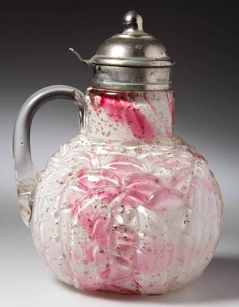 NORTHWOOD NO. 333 / LEAF MOLD SYRUP PITCHER: NORTHWOOD NO. 333 / LEAF MOLD SYRUP PITCHER, Royal Silver/cased opal with cranberry spatter and mica flecks, applied colorless handle, period lid with patent information on collar. Northwood Glass Co.