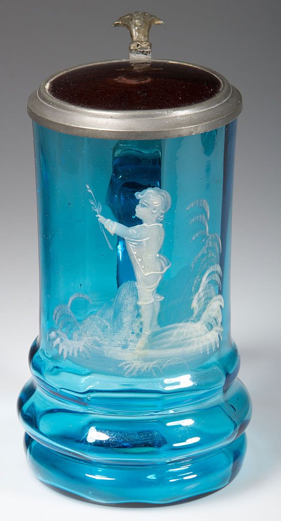 MARY GREGORY (SO CALLED) DECORATED RIB-OPTIC STEIN: MARY GREGORY (SO CALLED) DECORATED RIB-OPTIC STEIN, blue, painted in white enamel with a figure of a child, hinged Britannia and ruby-stained glass cover. Late 19th/early 20th century. 5 3/4" H.