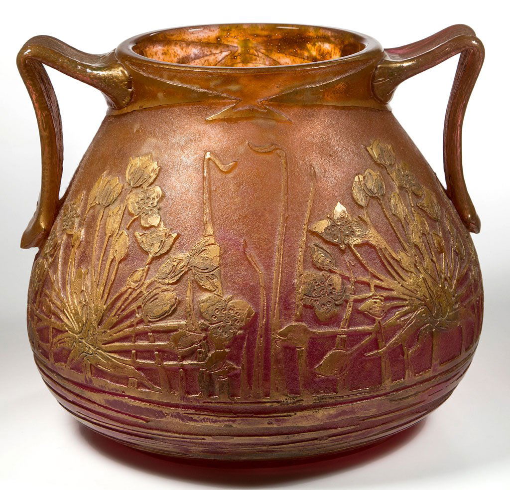 FRENCH DAUM NANCY ACID CUT-BACK VASE: FRENCH DAUM NANCY ACID CUT-BACK VASE, mottled amber to rose with green flakes, urn form with two applied handles, floral decoration with burnished gilt, signed under base. France. Late 19th/early 20th