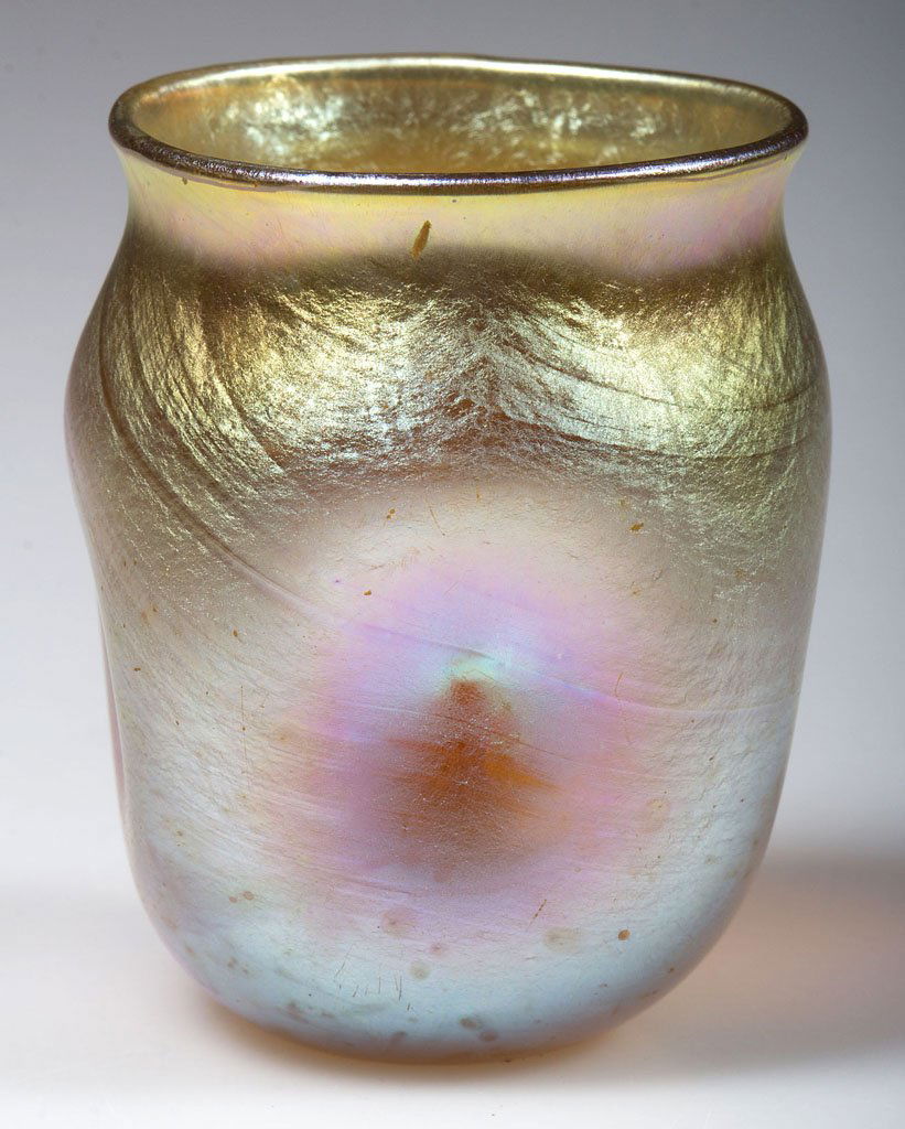 TIFFANY FAVRILE TOOTHPICK HOLDER / LIQUOR TUMBLER: TIFFANY FAVRILE TOOTHPICK HOLDER / LIQUOR TUMBLER, gold iridescent, circular form with four pinched sides, signed "L.C.T. V2526" at the polished pontil mark. Louis Comfort Tiffany & Co. First quarter