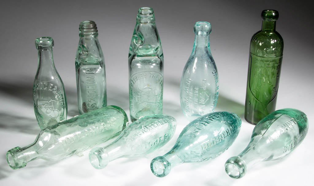 ASSORTED SODA AND SPRING WATER BOTTLES, LOT OF NINE: ASSORTED SODA AND SPRING WATER BOTTLES, LOT OF NINE, aquamarine and green, embossed, Codd-neck form, torpedo form, and one cylindrical form, applied mouths. Several English examples. Fourth quarter 19