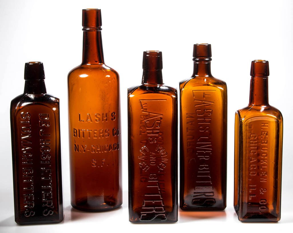 ASSORTED BITTERS BOTTLES, LOT OF FIVE: ASSORTED BITTERS BOTTLES, LOT OF FIVE, amber, various sizes, square and cylindrical forms, embossed for Lash's Bitters, Electric Brand Bitters, and Dr. J. Hostetter's Stomach Bitters, collared ring mo