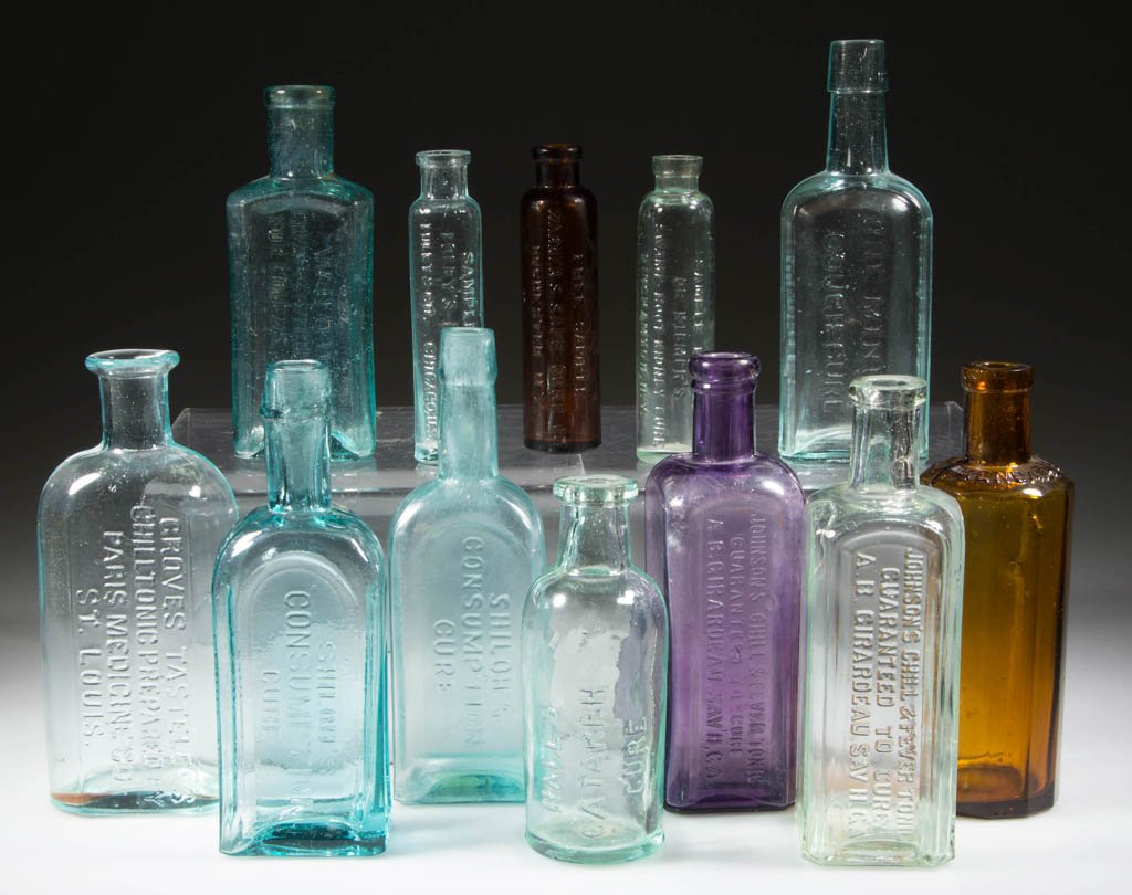 ASSORTED EMBOSSED CURE MEDICINE BOTTLES, LOT OF 12: ASSORTED EMBOSSED CURE MEDICINE BOTTLES, LOT OF 12, amber, amethyst, aquamarine, and light green, including one amethyst and one light green example embossed "JOHNSON'S CHILL & FEVER TONIC / GUARANTEE