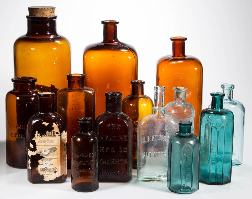 ASSORTED CHEMIST AND MEDICINE BOTTLES, LOT OF 14: ASSORTED CHEMIST AND MEDICINE BOTTLES, LOT OF 14, amber, aquamarine, and blue, many embossed or paper label, some with applied mouths. Fourth quarter 19th century/first half 20th century. 6" to 13 1/2