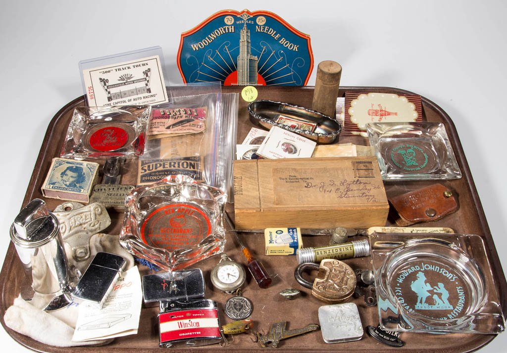 ASSORTED ADVERTISING AND OTHER ITEMS: ASSORTED ADVERTISING AND OTHER ITEMS, uncounted lot, including Zippo lighters, glass advertising ash trays, packs of phonograph needles, a brass Spirit of St. Louis, NY to Paris, May 21, 1927 figural