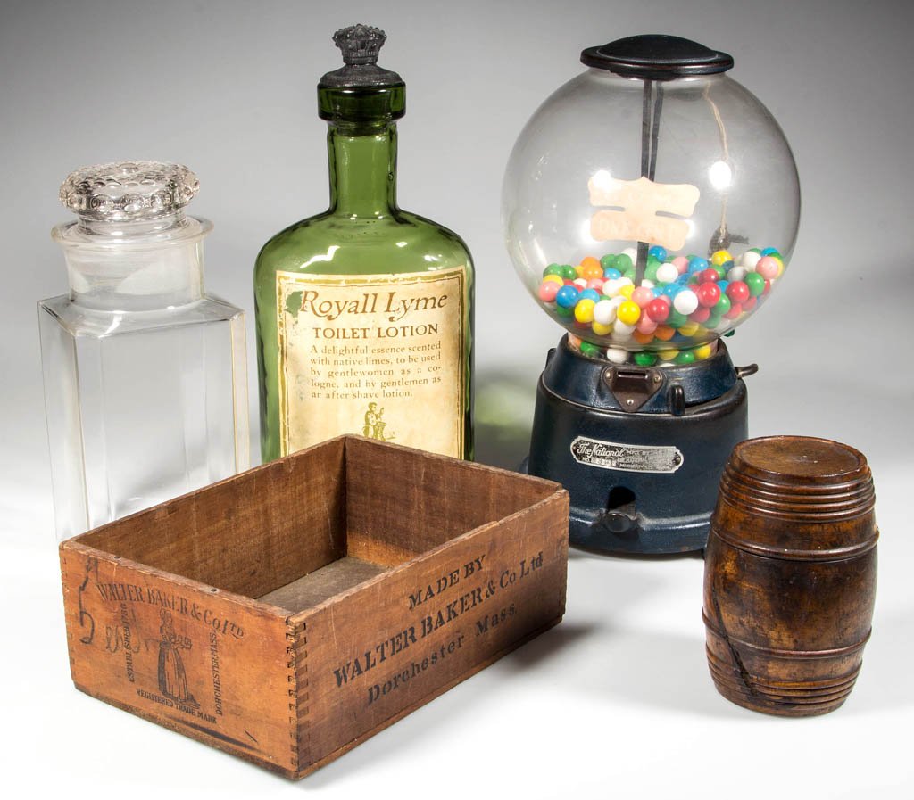 ASSORTED COUNTRY STORE ARTICLES, LOT OF FIVE: ASSORTED COUNTRY STORE ARTICLES, LOT OF FIVE, including a one cent bubble gum machine, a Baker's chocolate wooden shipping crate, and a Royall Lyme display bottle. 20th century. Bottle 14 1/2" H. Prov