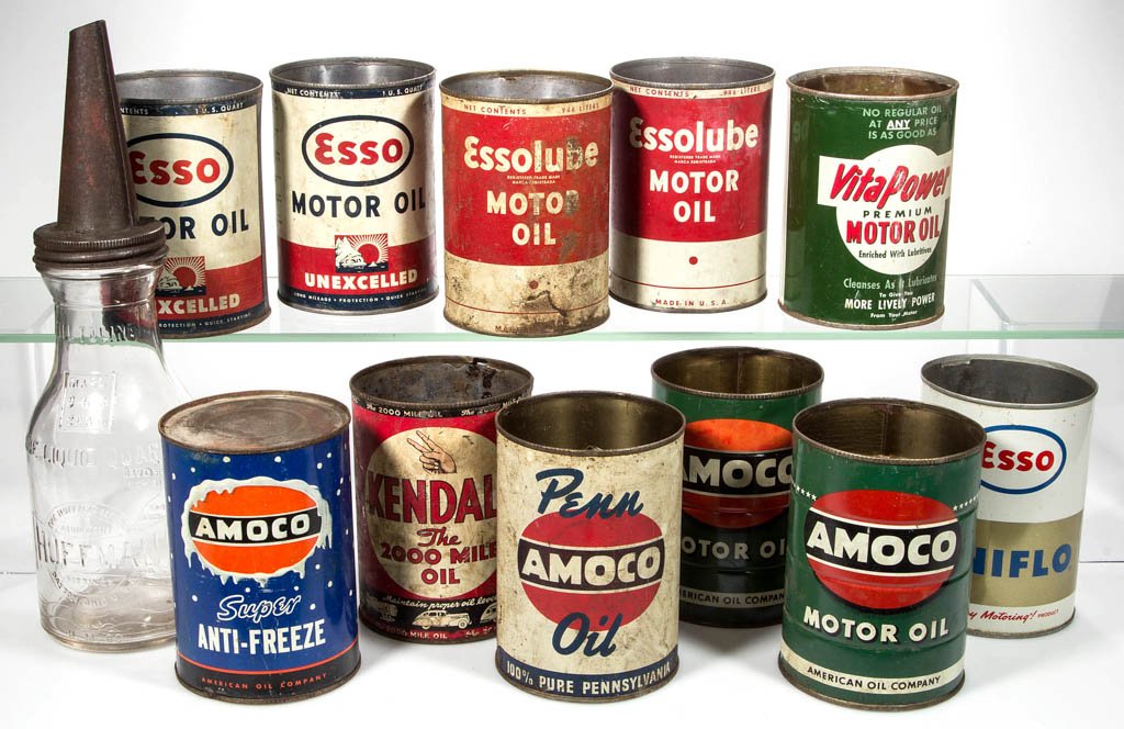 ASSORTED MOTOR OIL CONTAINERS, LOT OF 12: ASSORTED MOTOR OIL CONTAINERS, LOT OF 12, comprising 11 tin quart cans and a Huffman glass quart bottle with cap. Circa 1940-1960. 5 1/2" and 13 1/2" H. Provenance: From the collection of Janet and th