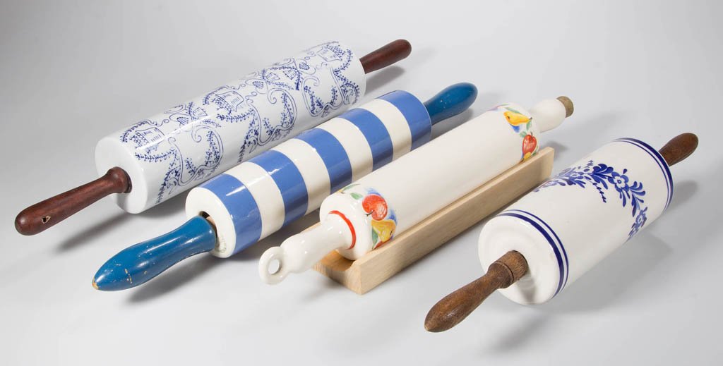 DECORATED CERAMIC ROLLING PINS, LOT OF TWO: DECORATED CERAMIC ROLLING PINS, LOT OF TWO, white, comprising a Harker example with pear and apple transfer decoration, one ring handle and other handle with cork; and a blue and white stripe English
