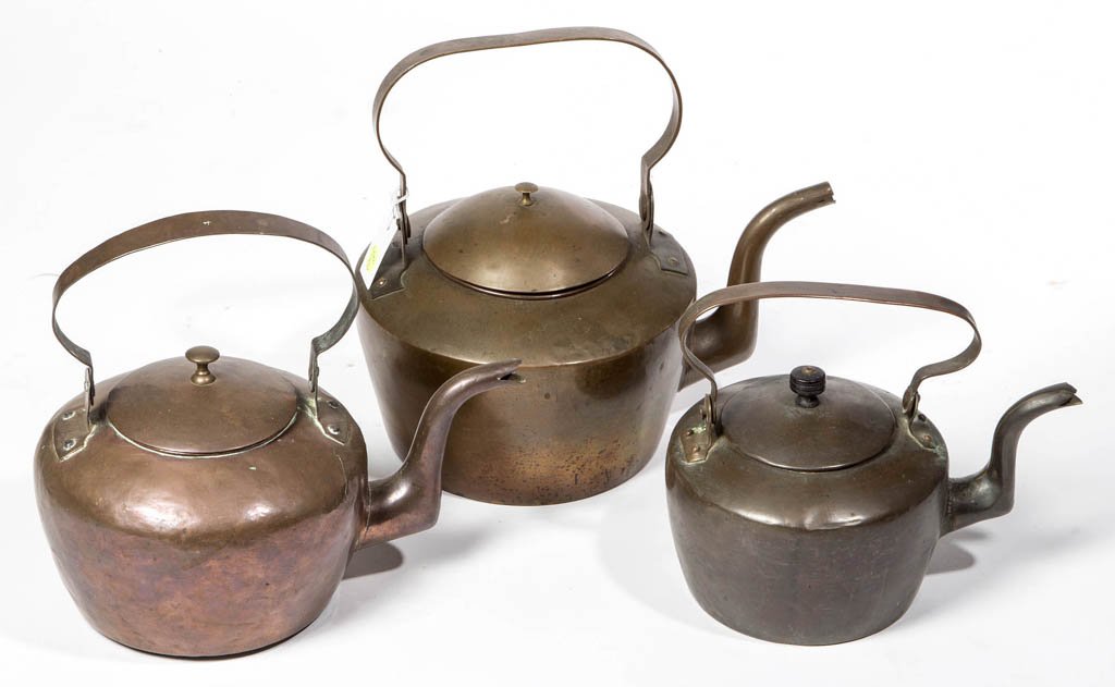 ASSORTED COPPER TEA KETTLES, LOT OF THREE: ASSORTED COPPER TEA KETTLES, LOT OF THREE, each with dovetailed construction, goose-neck spout, and swinging handle, one impressed "4" to the top of handle. First half 19th century. 9" to 11" HOA. Pro
