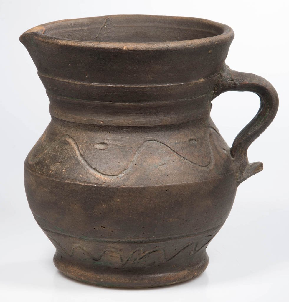 AMERICAN ART POTTERY PITCHER: AMERICAN ART POTTERY PITCHER, earthenware, squat form with deeply incised sine-wave decoration around shoulder and above foot, additional dashes between shoulder waves. Probably North Carolina, possib