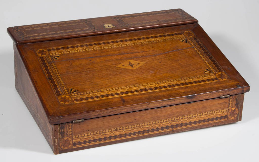 AMERICAN INLAID WALNUT LAP DESK: AMERICAN INLAID WALNUT LAP DESK, an elaborate example with inlaid marquetry designs, inlaid bone escutcheon, and developed interior with two small drawers. Poplar secondary wood. Includes early ink an