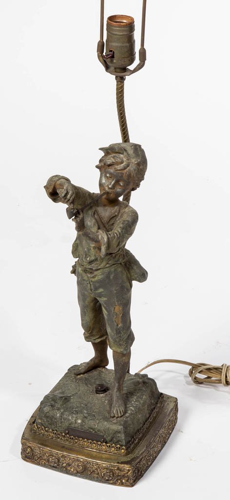 VICTORIAN PATINATED SPELTER STATUE MOUNTED AS A TABLE: VICTORIAN PATINATED SPELTER STATUE MOUNTED AS A TABLE LAMP, depicting a young boy lighting his long-stem pipe, plaque lettered "FLANUER" at base. Fourth quarter 19th century. Statue 15" H. Provenance: