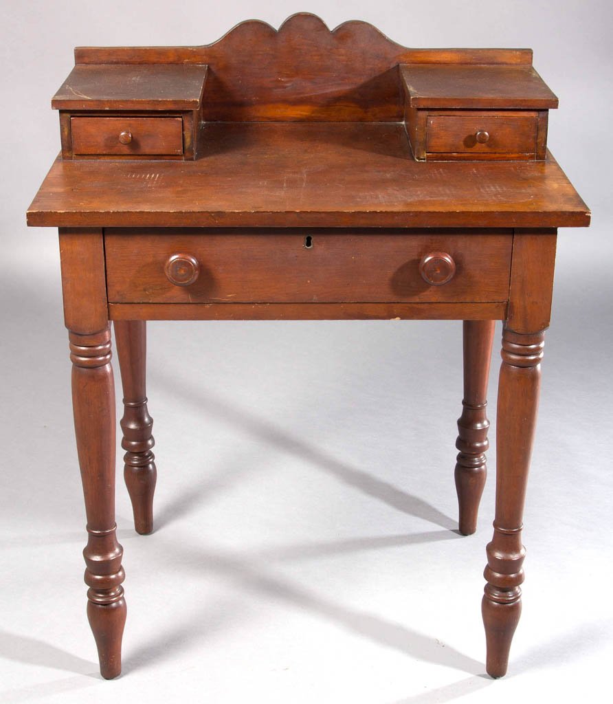 KENTUCKY LATE FEDERAL CHERRY STAND TABLE: KENTUCKY LATE FEDERAL CHERRY STAND TABLE, a bold vernacular form with shaped backsplash and flanking glove boxes over a rectangular top above a single drawer raised on robust ring-turned legs ending i