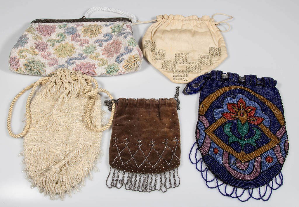VINTAGE BEADED LADY'S PURSES, LOT OF FIVE: VINTAGE BEADED LADY'S PURSES, LOT OF FIVE, comprising four draw-string and one metal frame labeled "Style by Laura, USA" on interior. Circa 1925-1970. Largest 6" x 10". Provenance: Property of a Winch