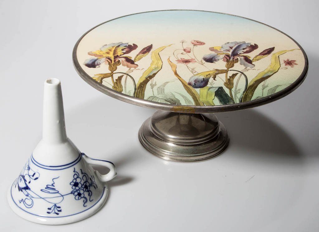 ASSORTED DECORATED CERAMIC ARTICLES, LOT OF TWO: ASSORTED DECORATED CERAMIC ARTICLES, LOT OF TWO, comprising a cake stand with Iris decorated ceramic plate and nickel-plated base, underside of foot with hallmark containing two fish in an oval; and a