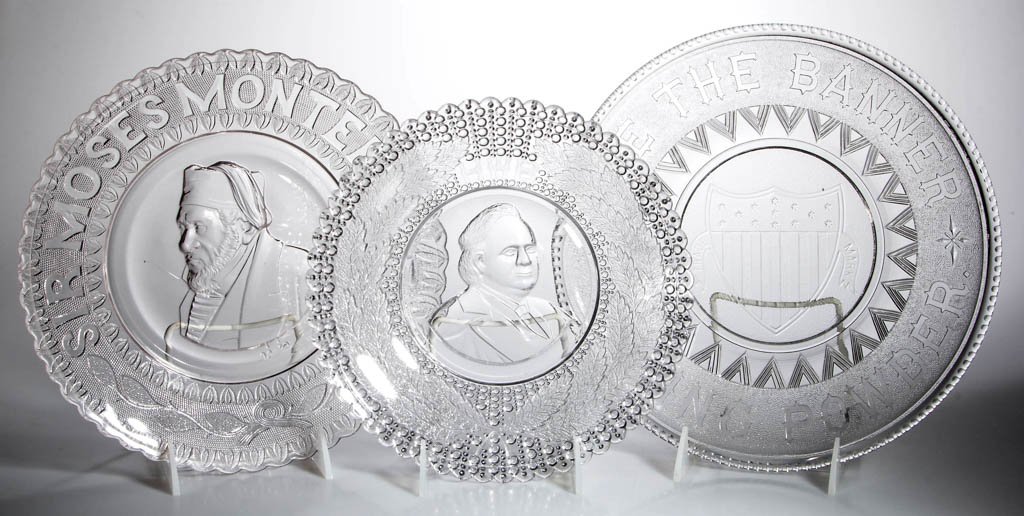 ASSORTED HISTORICAL BREAD PLATES, LOT OF THREE: ASSORTED HISTORICAL BREAD PLATES, LOT OF THREE, colorless, comprising a Banner Baking Powder, Henry Ward Beecher, and Sir Moses Montefiore. Fourth quarter 19th century. 9 1/4" to 10 7/8" D. Provenance