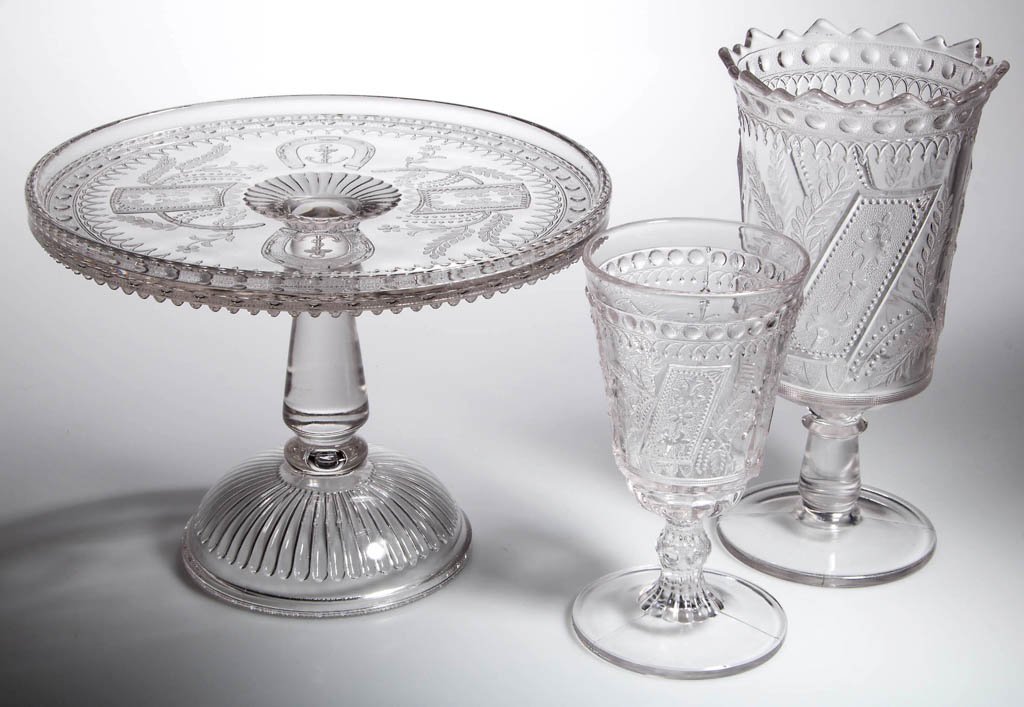 GOOD LUCK / HORSESHOE TABLE ARTICLES, LOT OF THREE: GOOD LUCK / HORSESHOE TABLE ARTICLES, LOT OF THREE, colorless, comprising a cake stand, a celery vase, and a goblet with fancy stem. Fourth quarter 19th century. 6 1/4" to 8 1/2" H, cake stand 9" D. P