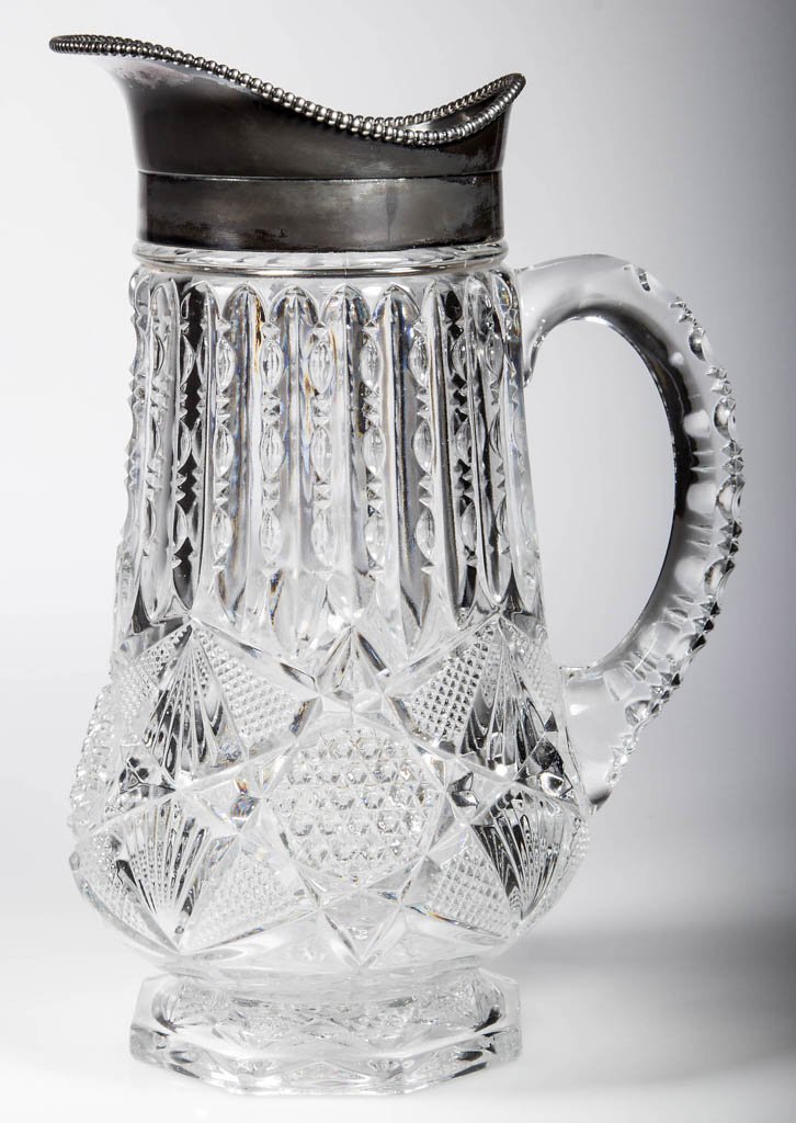 ILLINOIS / CLARISSA CHAMPAGNE PITCHER: ILLINOIS / CLARISSA CHAMPAGNE PITCHER, colorless, with silver-plated mouth. U.S. Glass Co. Circa 1897. 11" H. Provenance: Collection of John W. Ragsdale, Broken Arrow, OK.