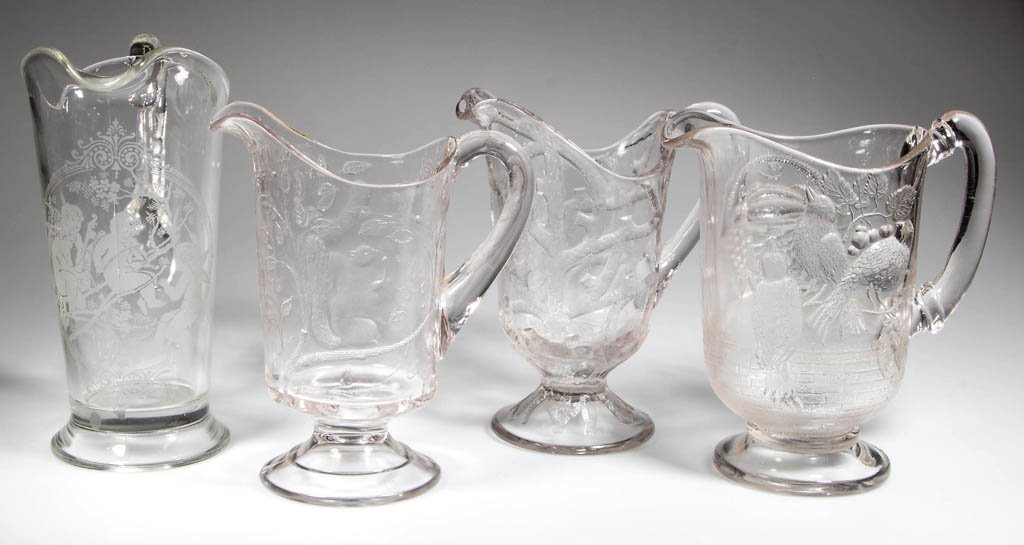 ASSORTED FINDLAY WATER PITCHERS, LOT OF FOUR: ASSORTED FINDLAY WATER PITCHERS, LOT OF FOUR, colorless, comprising a Three Birds Variant with brickwork below pattern, Branched Tree, Squirrel, and Etched Cupids. Dalzell, Gilmore & Leighton Co., Fin