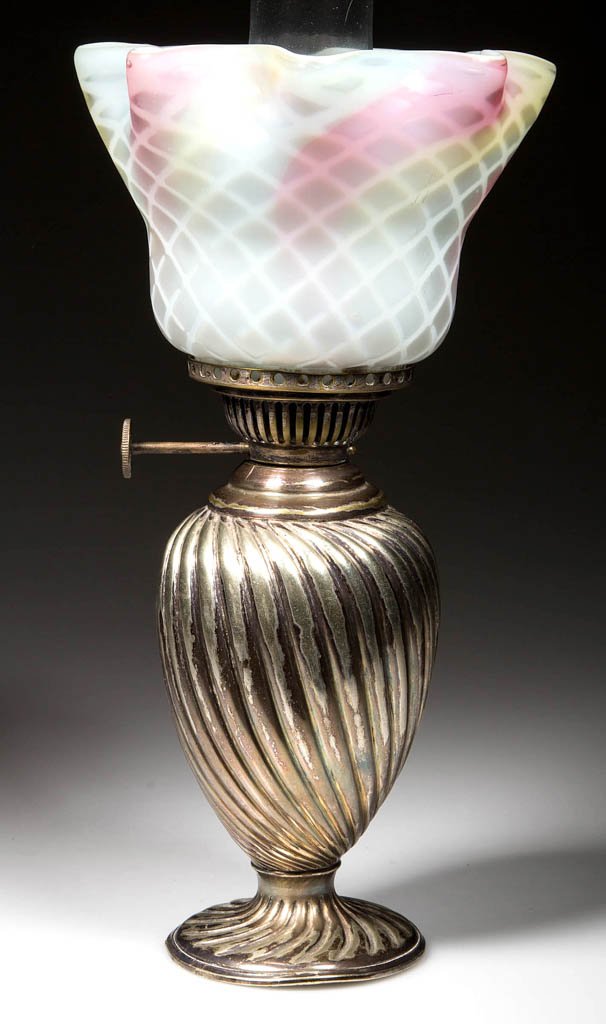 SILVER-PLATE AND ART GLASS MINIATURE OIL LAMP: SILVER-PLATE AND ART GLASS MINIATURE OIL LAMP, rainbow Diamond Quilt air-trap mother-of-pearl shade, on a silver-plate base with weighted foot and embossed swirl pattern. The base is stamped on the un