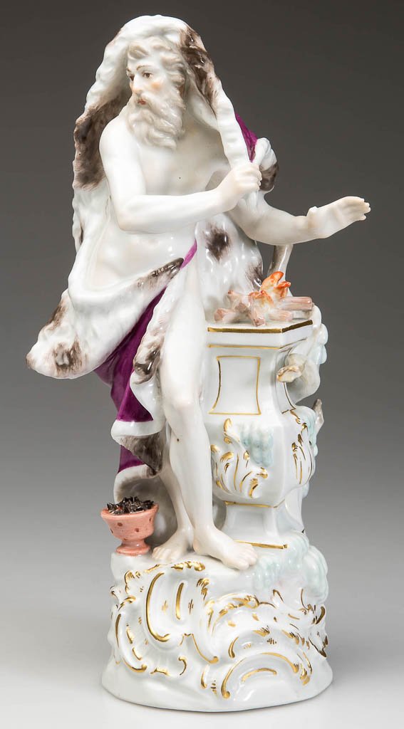 GERMAN MEISSEN PORCELAIN ALLEGORICAL FIGURE OF WINTER: GERMAN MEISSEN PORCELAIN ALLEGORICAL FIGURE OF WINTER, the standing figure of an old man, swathed in a fur-lined puce cape, beside a neoclassical plinth topped by fire, a bucket of coals to his right,