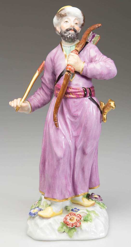 GERMAN MEISSEN PORCELAIN FIGURE OF A CIRCASSIAN OR: GERMAN MEISSEN PORCELAIN FIGURE OF A CIRCASSIAN OR TURKISH HUNTER, the standing figure of a male with ermine-ringed turban and purple coat, a bow in his left hand and arrow in his right, with sheathed