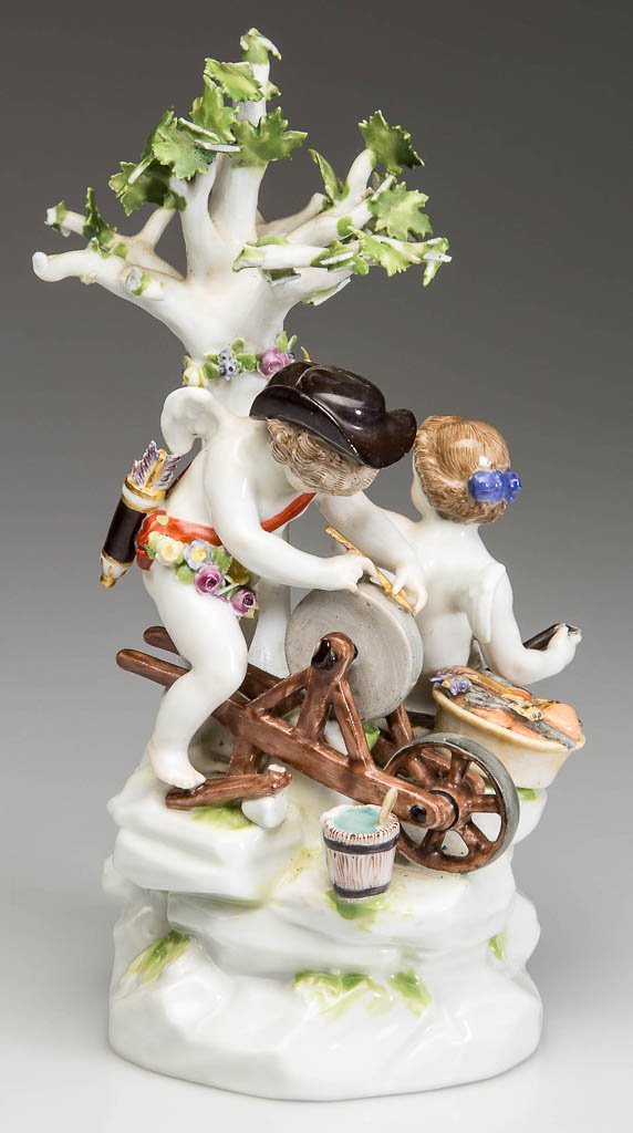 GERMAN MEISSEN PORCELAIN FIGURAL GROUP OF CUPID: GERMAN MEISSEN PORCELAIN FIGURAL GROUP OF CUPID SHARPENING ARROW, two figures on a rocky, mounded base under a tree: cupid, with a tricorne hat, sharpening an arrow, with tools and basket of hearts an