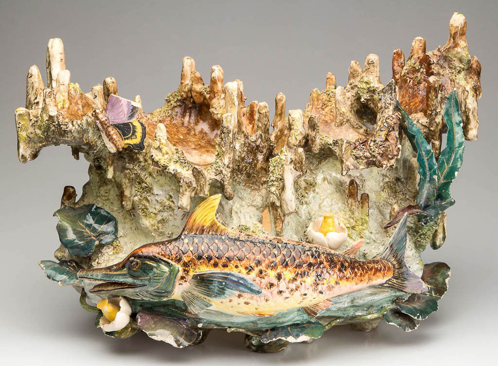 FRENCH FAIENCE BOWL WITH APPLIED FISH: FRENCH FAIENCE BOWL WITH APPLIED FISH, low, ovular and formed as a grotto, with fantastical stalagmite edges, molded organically as a sea fantasy, with scrolling curves and applied dried clay for text