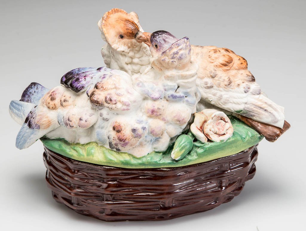 GERMAN OR CONTINENTAL PORCELAIN BISCUIT AND GLAZED: GERMAN OR CONTINENTAL PORCELAIN BISCUIT AND GLAZED COVERED DISH, small, ovular, the glazed base molded to appear as a brown basket, the unglazed cover molded with two loving doves seated on a grassy m