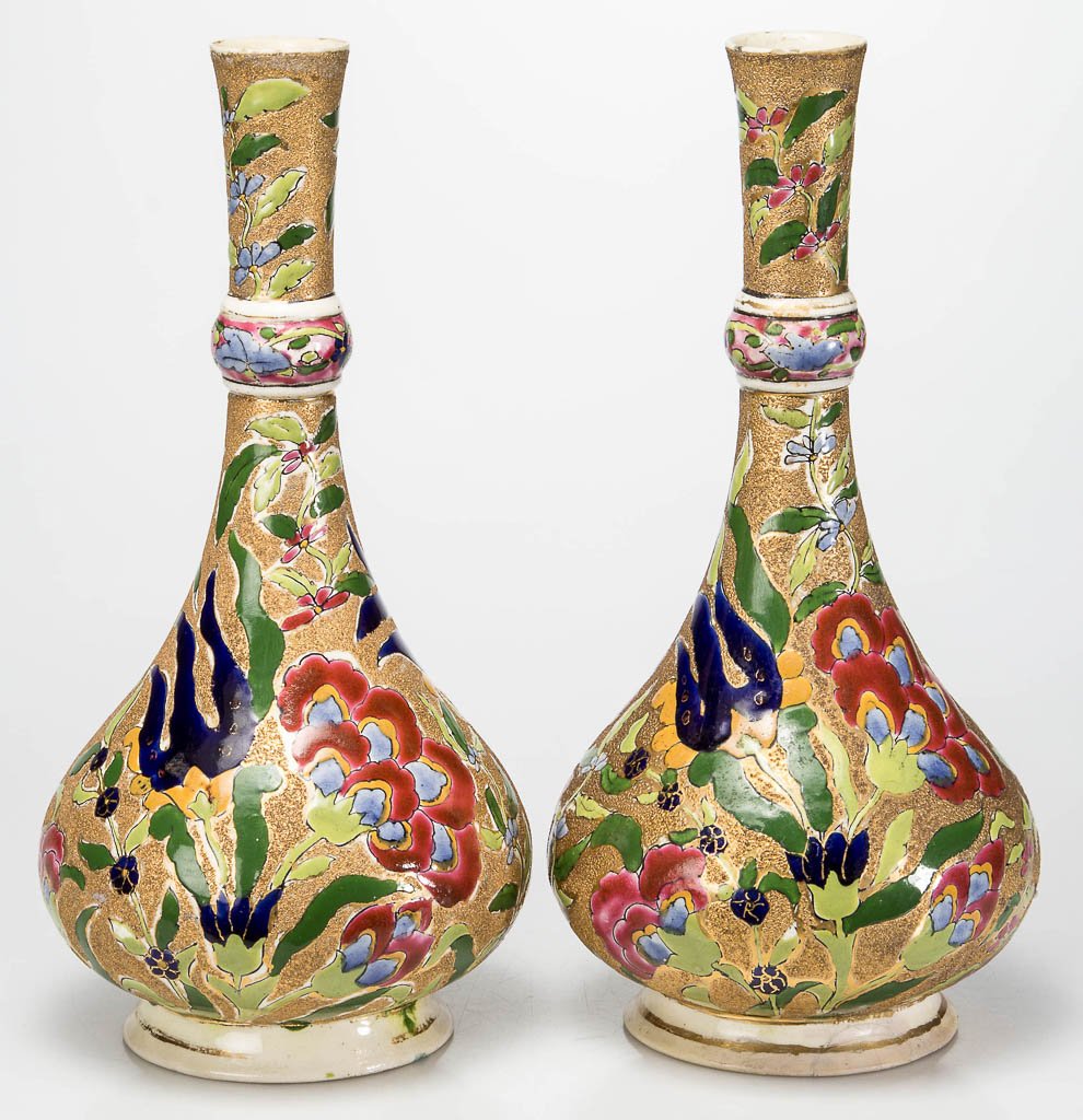 CONTINENTAL HUNGARIAN POTTERY HUNGARIAN J. FISCHER: CONTINENTAL HUNGARIAN POTTERY HUNGARIAN J. FISCHER ZSOLNAY PAIR OF VASES, gourd-shaped with elongated necks on waisted ankles and swelling feet, with colorful flowers and plants in reserves on the mat