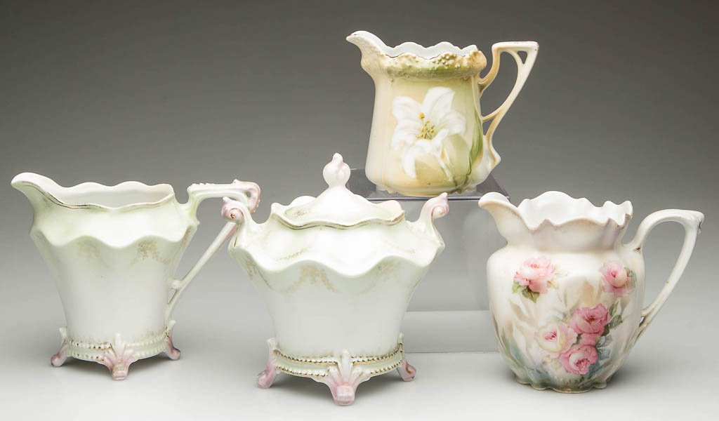 GERMAN R.S. PRUSSIA PORCELAIN TABLEWARE ARTICLES, LOT: GERMAN R.S. PRUSSIA PORCELAIN TABLEWARE ARTICLES, LOT OF FOUR, comprising a footed sugar bowl and cover, and a cream jug, in mold #74 shape, printed with gilt swagged garlands, on satin-finish bodies,