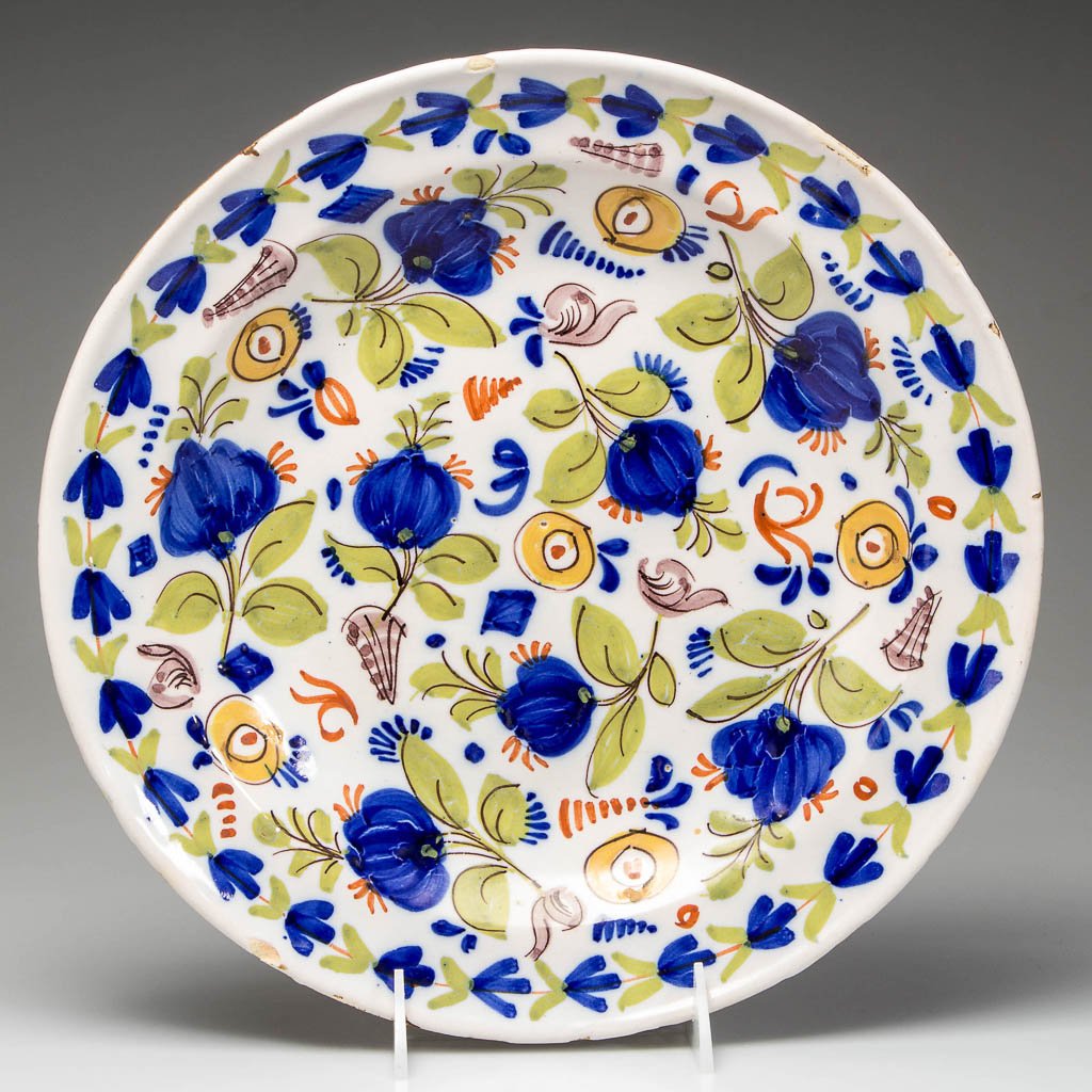 CONTINENTAL FAIENCE TIN-GLAZED BOWL: CONTINENTAL FAIENCE TIN-GLAZED BOWL, rimmed, painted with an allover floral pattern, unmarked. 19th century. 12 1/4" D. Provenance: Property of a Virginia private collector.