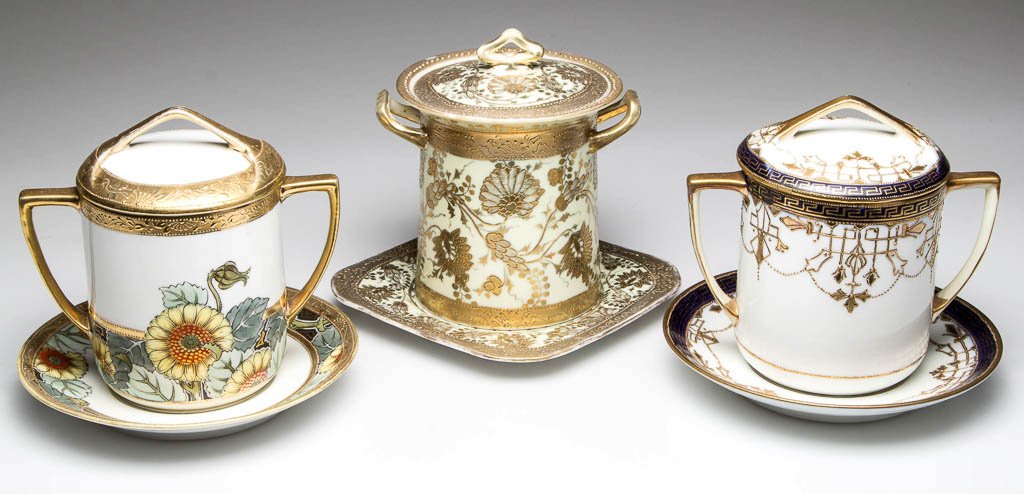 JAPANESE NIPPON PORCELAIN CONDENSED MILK SETS, LOT OF: JAPANESE NIPPON PORCELAIN CONDENSED MILK SETS, LOT OF THREE, each comprising a cylindrical-molded milk sheath, domed cover and underplate, each painted and printed with elaborate paste-gilt motifs, on