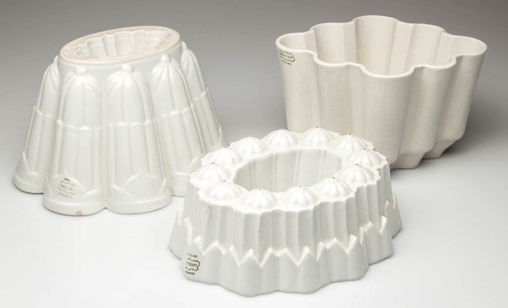 ENGLISH SHELLEY IRONSTONE SHAPED JELLY OR ASPIC MOLDS,: ENGLISH SHELLEY IRONSTONE SHAPED JELLY OR ASPIC MOLDS, LOT OF THREE, each in plain white with distinctive modeling to the interior. Various printed marks to outer walls. Circa 1930. 4 1/2" HOA. Proven