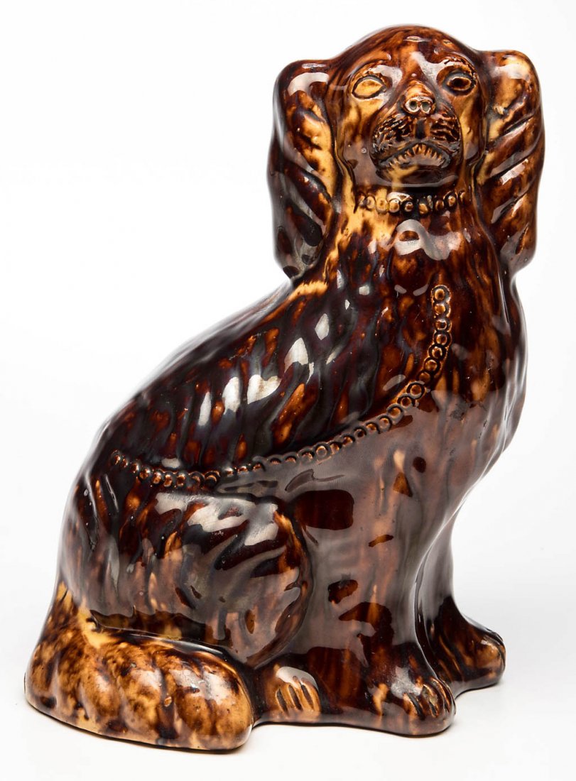 RARE STAMPED "JOHN BELL", WAYNESBORO, PENNSYLVANIA: RARE STAMPED "JOHN BELL", WAYNESBORO, PENNSYLVANIA EARTHENWARE / REDWARE SPANIEL FIGURE, mottled manganese- and lead-glaze over yellow slip, right facing hollow seated figure molded after English Staf