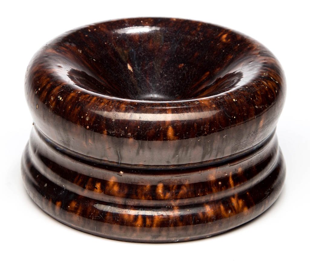 STAMPED "JOHN BELL / WAYNESBORO", PENNSYLVANIA: STAMPED "JOHN BELL / WAYNESBORO", PENNSYLVANIA EARTHENWARE / REDWARE SPITTOON, mottled manganese- and lead-glazed, circular form with a medial collar and oval drain hole, stamped under base. John B. B